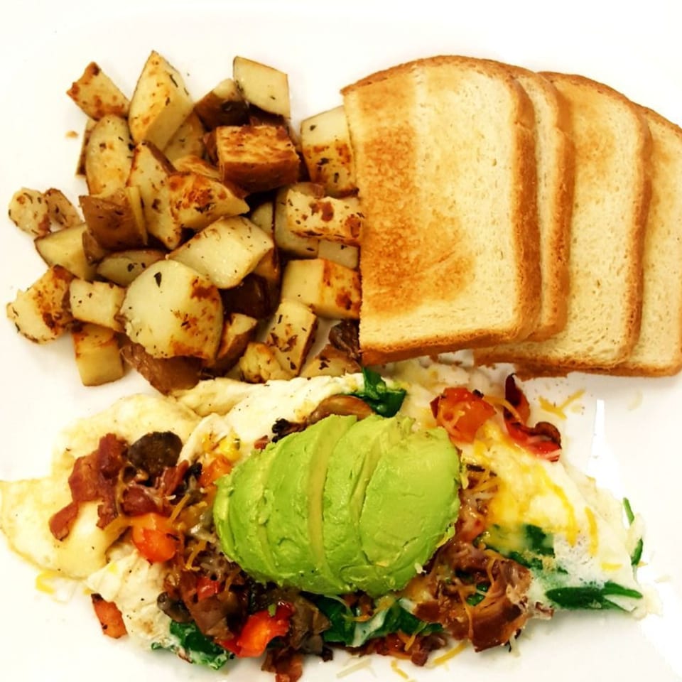 Springdale Cafe's breakfast plate with scrambled eggs, avocado, home fries, and toast.